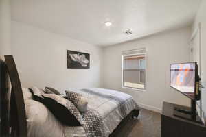 Carpeted bedroom with baseboards