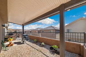 View of patio featuring a residential view, a fenced backyard, and a grill