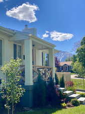 View of home's exterior with a chimney, a mountain view, and covered porch