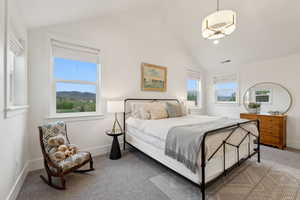 Bedroom with carpet flooring, baseboards, and high vaulted ceiling
