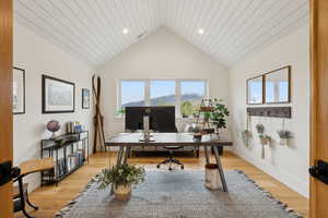 Office area with lofted ceiling, light wood-type flooring, recessed lighting, and baseboards