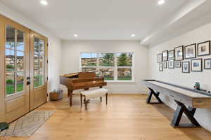 Foyer entrance featuring recessed lighting, plenty of natural light, light wood-style floors, and french doors