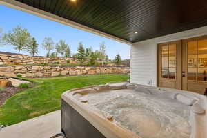 View of patio featuring a hot tub