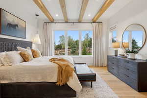 Bedroom with beam ceiling, light wood-type flooring, and recessed lighting