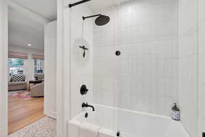 Bathroom featuring shower / bath combination, recessed lighting, and wood finished floors