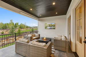 View of patio featuring an outdoor living space with a fire pit