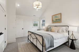 Bedroom featuring carpet flooring, baseboards, lofted ceiling, and recessed lighting