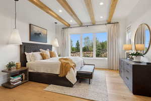 Bedroom with beamed ceiling, light wood-style floors, recessed lighting, and baseboards