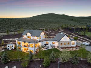 Aerial view of property and surrounding area with a mountain backdrop