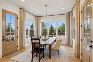 Dining space featuring a chandelier, wooden ceiling, light wood-style flooring, and recessed lighting