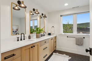 Full bath featuring double vanity, tile patterned flooring, baseboards, and recessed lighting