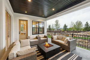 View of patio with an outdoor living space with a fire pit