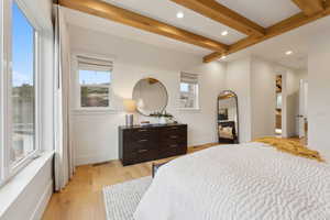 Bedroom featuring recessed lighting, beamed ceiling, light wood finished floors, and baseboards