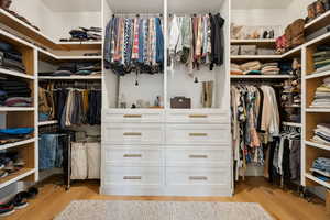 Spacious closet with light wood-style floors