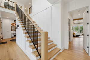 Staircase with hardwood / wood-style floors, recessed lighting, and baseboards