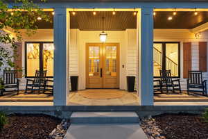 Doorway to property featuring a porch and french doors