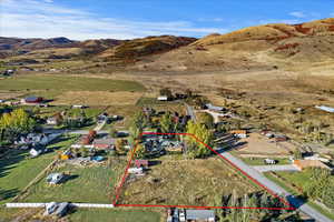Aerial view of property's location with property parcel outlined and a mountain backdrop