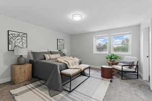 Bedroom featuring carpet and baseboards