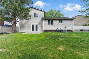 Back of property with central AC unit and a patio area