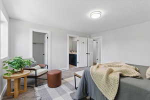 Carpeted bedroom featuring baseboards and a closet