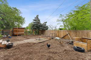 View of yard featuring fence and exterior structure