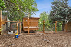 View of yard with exterior structure, an outdoor structure, and fence