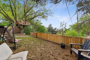 Fenced backyard with a storage unit