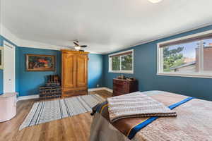 Bedroom with wood finished floors and baseboards