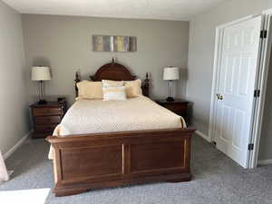 Bedroom featuring carpet floors and baseboards
