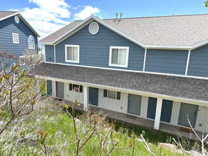 View of front of home featuring roof with shingles and board and batten siding