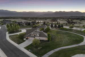 View of community featuring concrete driveway, a mountain view, and a residential view