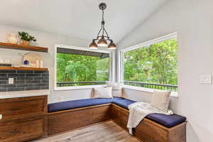 Sitting room featuring lofted ceiling, wood finished floors, and a textured ceiling