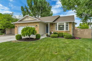 Ranch-style home featuring a garage, brick siding, driveway, and a shingled roof