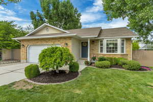 Ranch-style house featuring a garage, concrete driveway, brick siding, and roof with shingles