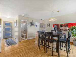 Dining room with light wood-style flooring and baseboards