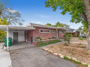 View of front of home featuring brick siding and asphalt driveway