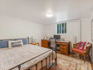 Bedroom featuring light wood-type flooring and a desk