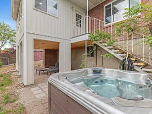 View of swimming pool featuring a hot tub and fence