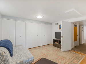Bedroom featuring multiple closets, wood finished floors, and baseboards
