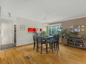 Dining area with wood finished floors and baseboards