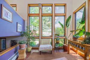 Sunroom featuring baseboard heating