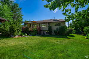 Back of house with a deck
