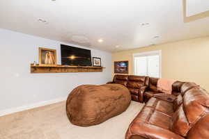 Living room featuring carpet flooring, recessed lighting, baseboards, and a textured ceiling
