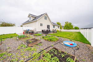 Rear view of property featuring a garden