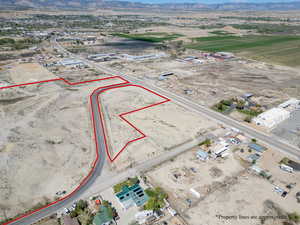 Drone / aerial view of a mountain backdrop and a desert landscape
