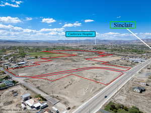Aerial overview of property's location featuring a mountainous background and property boundaries highlighted