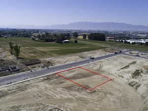 Aerial view of sparsely populated area featuring property boundaries highlighted and mountains