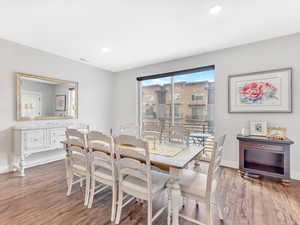 Dining space featuring wood finished floors, baseboards, and recessed lighting