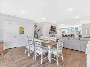 Dining area featuring light wood-style flooring, stairway, and recessed lighting