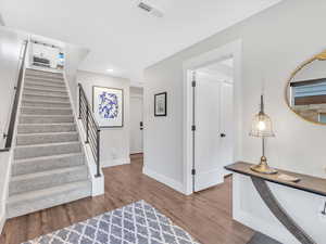 Stairway featuring wood finished floors and baseboards